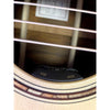 Close-up of an acoustic guitar's soundhole with a 'VOI' and 'mix' label.