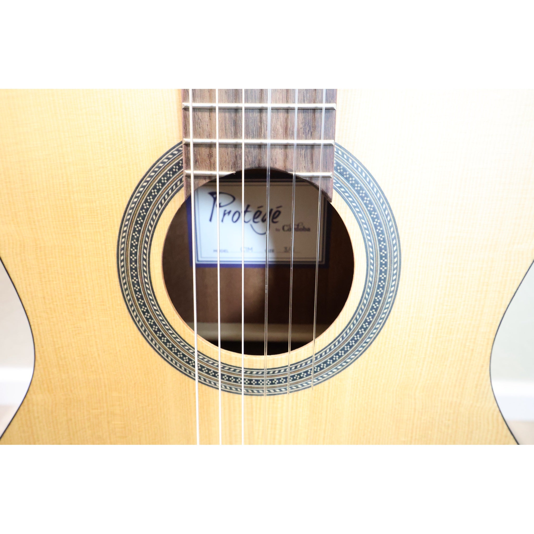 Protégé by Córdoba C1M 3/4 classical guitar, close-up of soundhole, label and mosaic rosette