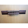 Protégé by Córdoba C1M 3/4 classical guitar, close-up of tie-block bridge with nylon strings