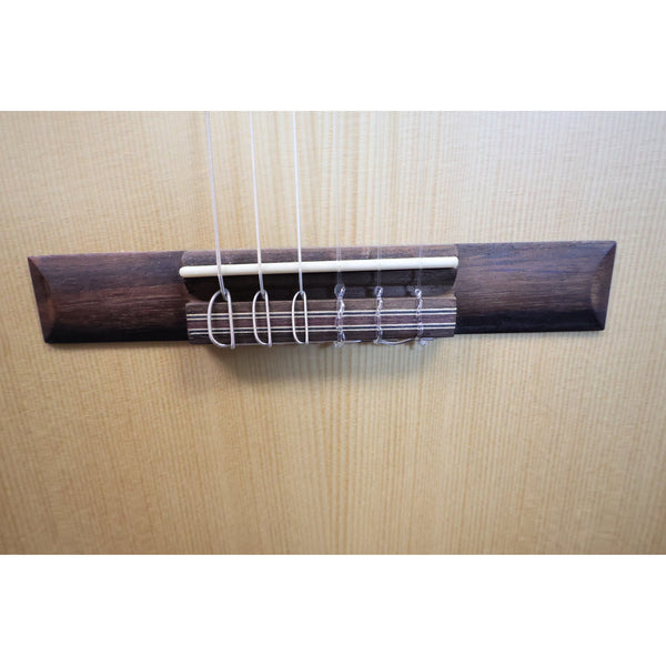 Protégé by Córdoba C1M 3/4 classical guitar, close-up of tie-block bridge with nylon strings