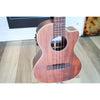A Kala KA-SA-TE-C All-Solid Acacia Tenor Cutaway Ukulele with Fishman Electronics ukulele   with a rich reddish-brown wood finish and dark fretboard, photographed standing on a light wood floor in an indoor setting at El Cajon Guitars & Music Shop.