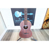 A A Kala KA-SA-B All-Solid Acacia Baritone Ukulele with a reddish-brown finish stands on a stand at ECGMusic with the body and grain showing.