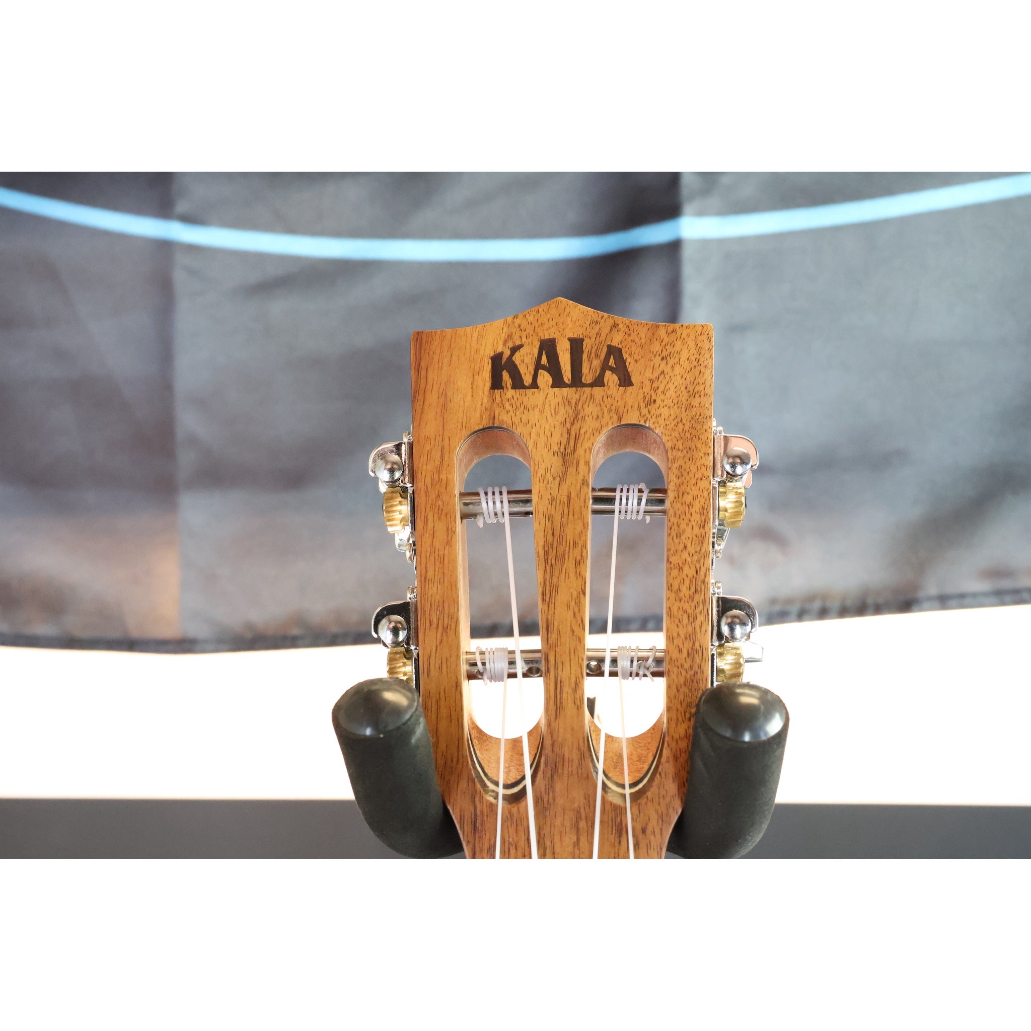 Close up of the Kala headstock on this Close-up of a A Kala KA-SA-TE-C All-Solid Acacia Tenor Cutaway Ukulele with Fishman Electronics.