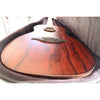 The Lâg Sauvage PE Parlor Acoustic-Electric Guitar in the hybrid case it comes with, providing great padding and protection.  The bronco wood grain  on the top is stunning, and you can see the edge of the rough cut side wood.