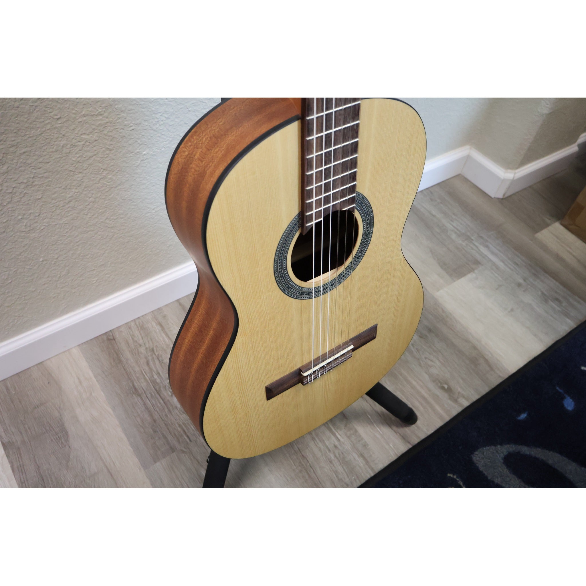 Protégé by Córdoba C1M 3/4 classical guitar, angled view of spruce top and mahogany side
