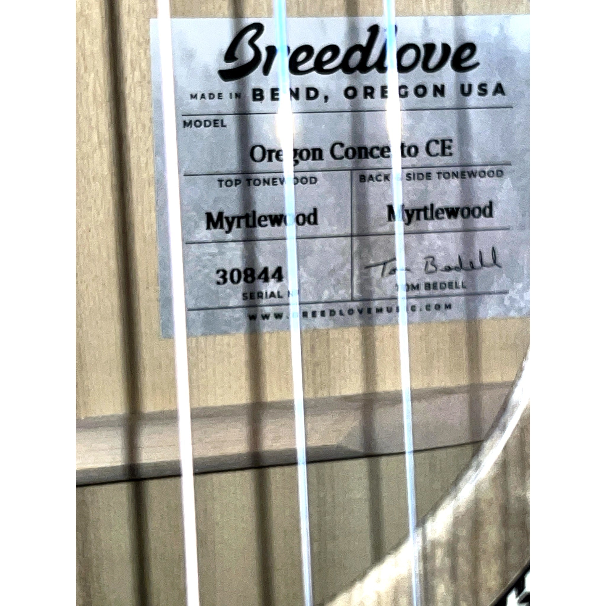 Interior Breedlove label showing serial number 30844, Bend Oregon craftsmanship details, and Tom Bedell signature