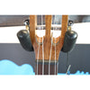 Close-up of a A Kala KA-SA-TE-C All-Solid Acacia Tenor Cutaway Ukulele with Fishman Electronics ukulele  mounted in a black guitar stand, with tuning pegs and strings visible against the ECGMusic logo.