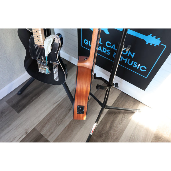 Córdoba Mini II Bass MH-E next to a full-size electric guitar, size comparison