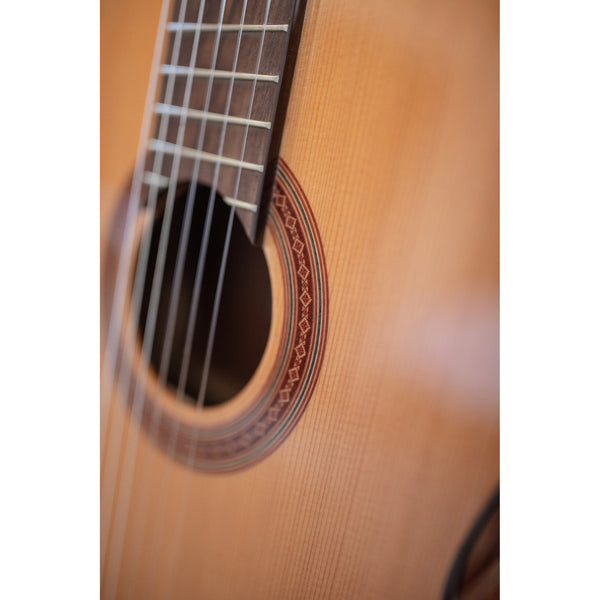 Córdoba C5 CD Close-up of a classical guitar's soundhole and wooden body.