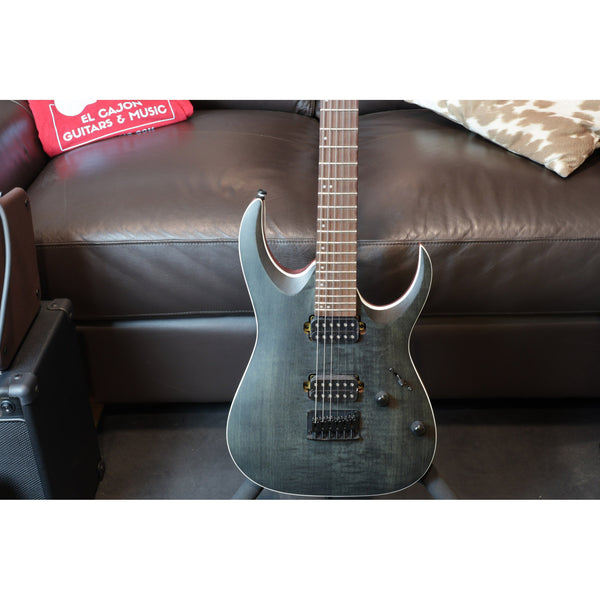 Electric guitar on a brown leather couch with a box in the background