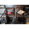 Electric guitar leaning against a brown leather couch with amplifiers on either side.