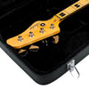 GWE-BASS Close-up of a guitar headstock with 'Fender' branding inside a black case.