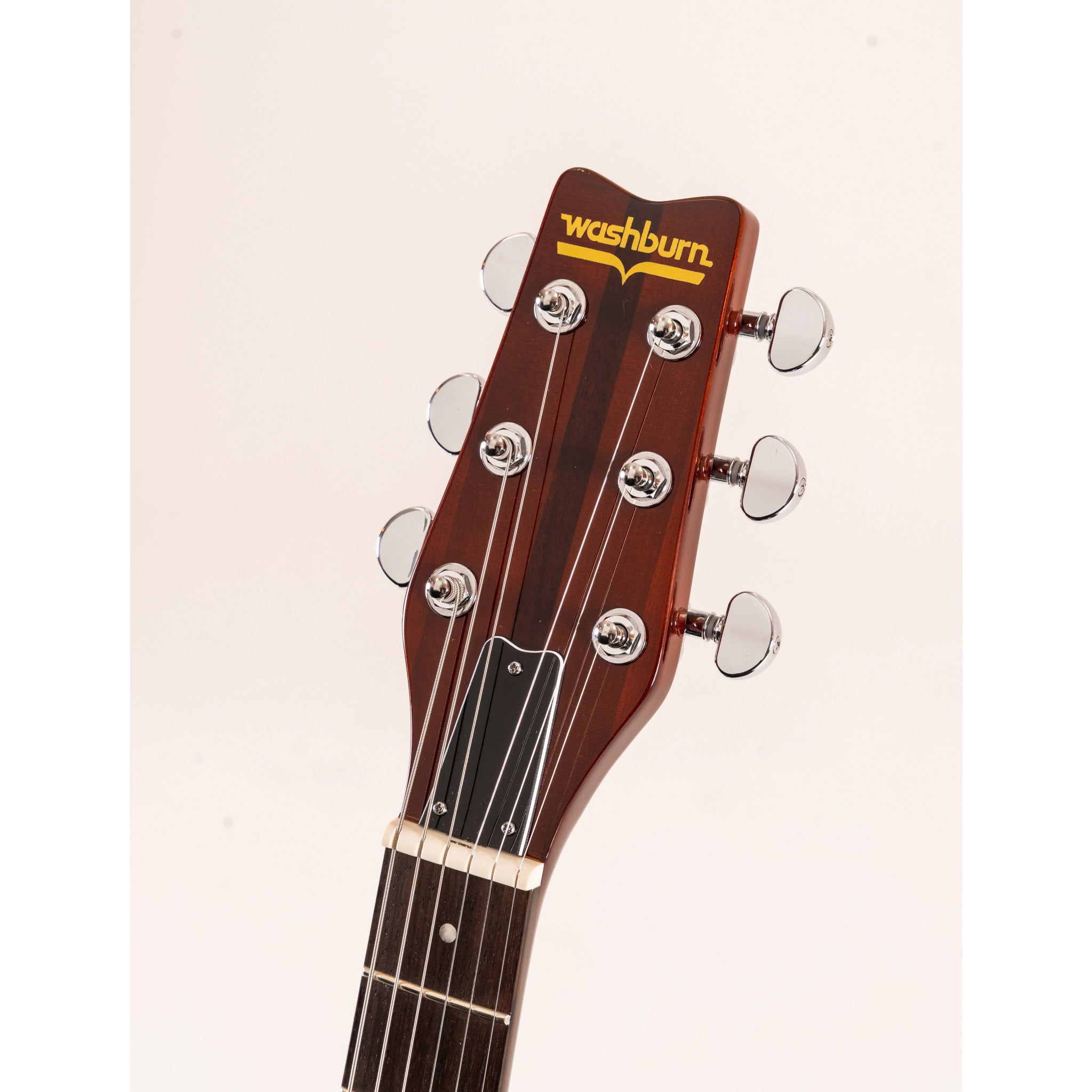 Guitar headstock with Washburn logo on a beige background