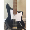 Ashdown Black electric bass guitar with a white pickguard on a wooden floor.