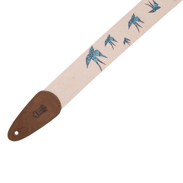 Guitar strap with bird pattern and brown end piece on a white background