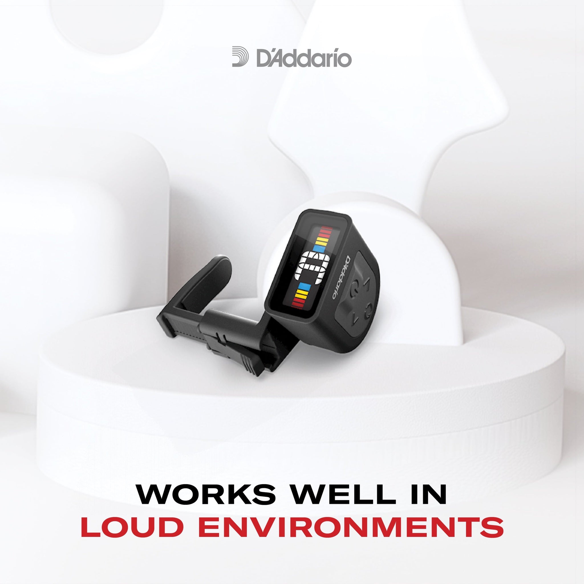 D'Addario guitar tuner on a white background with text about its effectiveness in loud environments