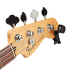Fender Precision Bass guitar headstock with tuning pegs and a digital tuner on a white background D'Addario PW-CT-13 Micro Universal Guitar Tuner.