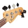 Close-up of a Fender Precision Bass headstock with four tuning pegs, four strings, and a black clip-on digital tuner attached near the tuning pegs, on a white background with a D'Addario PW-CT-13 Micro Universal Guitar Tuner