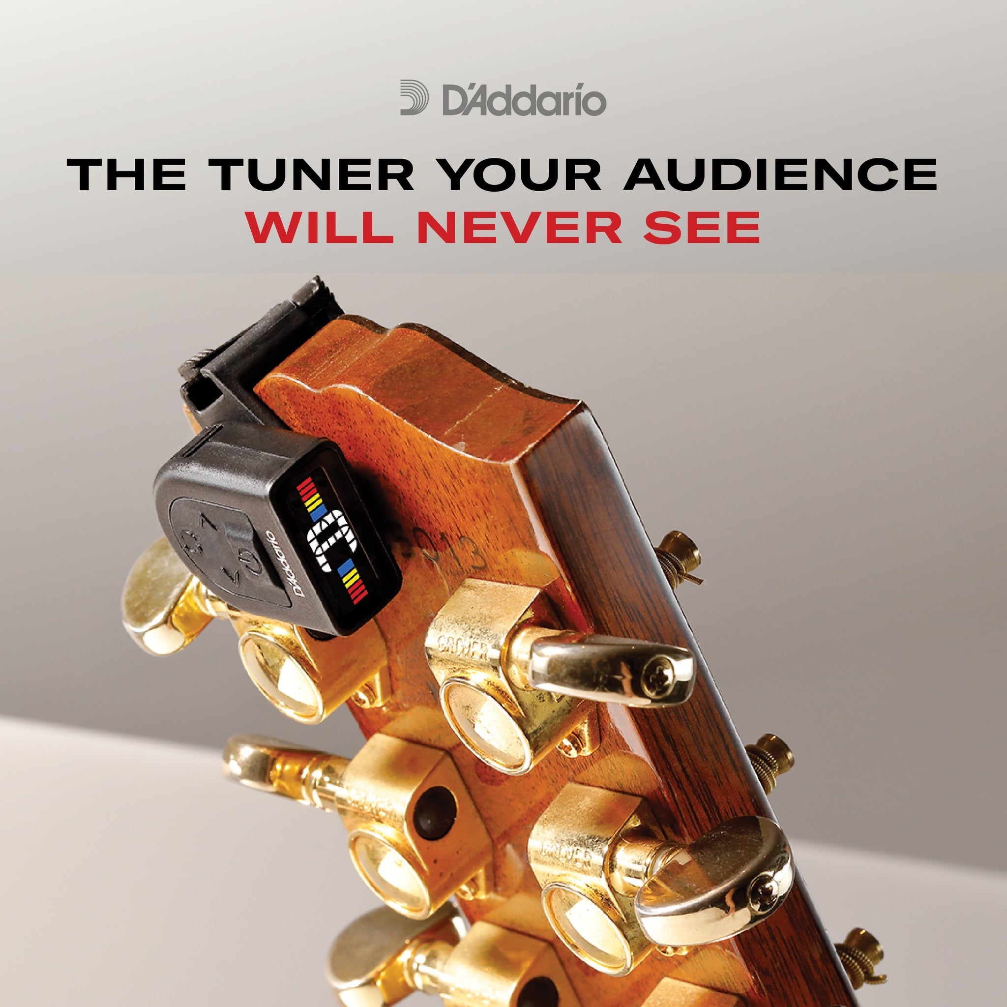D'Addario PW-CT-13 Micro Universal Guitar Tuner The Tuner Your Audience will Never see text over acoustic headstock with tuner on it.