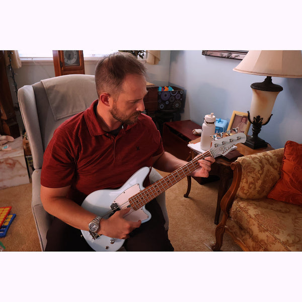 Man playing a bass guitar - Ashdown Mini Bass