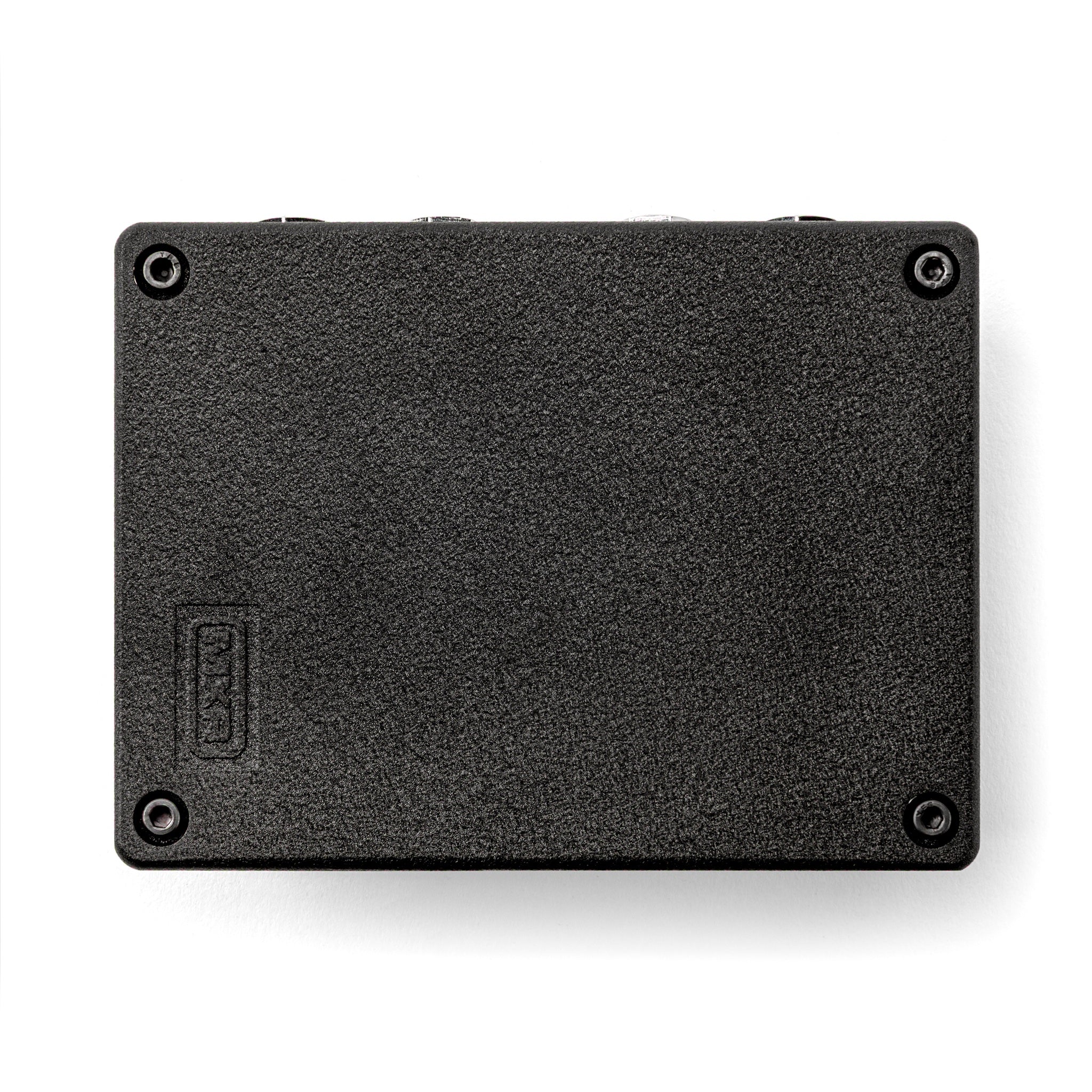 A MXR Flanger Doubler back black textured rectangular metal component, likely a hard drive enclosure or SSD casing, shown from the bottom side with four corner screws on a white background.