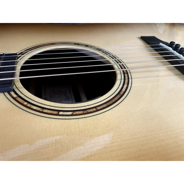 Close-up of an acoustic guitar's soundhole and strings