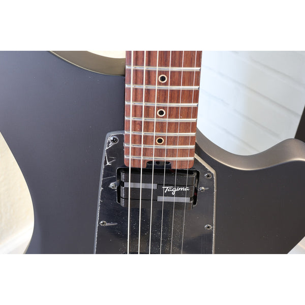 Tagima Rocker Cosmos Stealth electric guitar angled studio shot showing full offset silhouette with custom Lace Pickups.