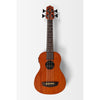 A Kala Nomad Acoustic-Electric U•BASS®  UBASS NOMAD  four-string acoustic ukulele with a warm orange-brown wood finish, black hardware, and white dot inlays on the neck, shown against a light gray background.