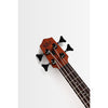 Close-up of the headstock of a Kala Nomad Acoustic-Electric U•BASS® - UBASS-NOMAD-FS, showing the brand name 'KALA' in black on a reddish-brown wood tone, with four black tuning keys and strings extending down the dark fretboard against a clean white background.