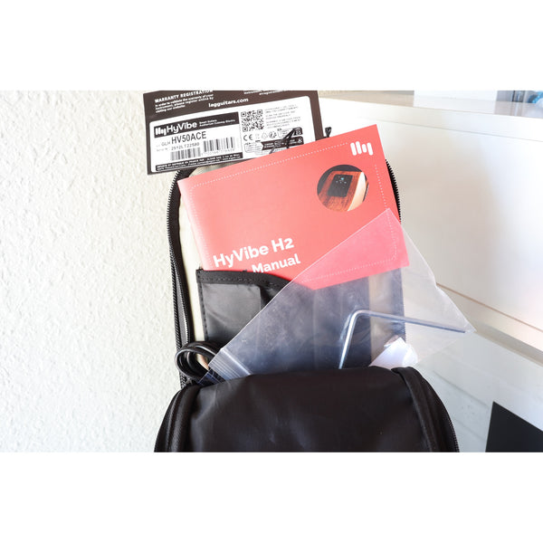 Lâg HyVibe 50 Auditorium Bevel Cutaway Smart Guitar – HV50ACE-2512LT22580 -with Warranty Registration & Serial Number card, HyVibe 2 Manual, Truss Tool, and USB charging cable in upper case pocket.
