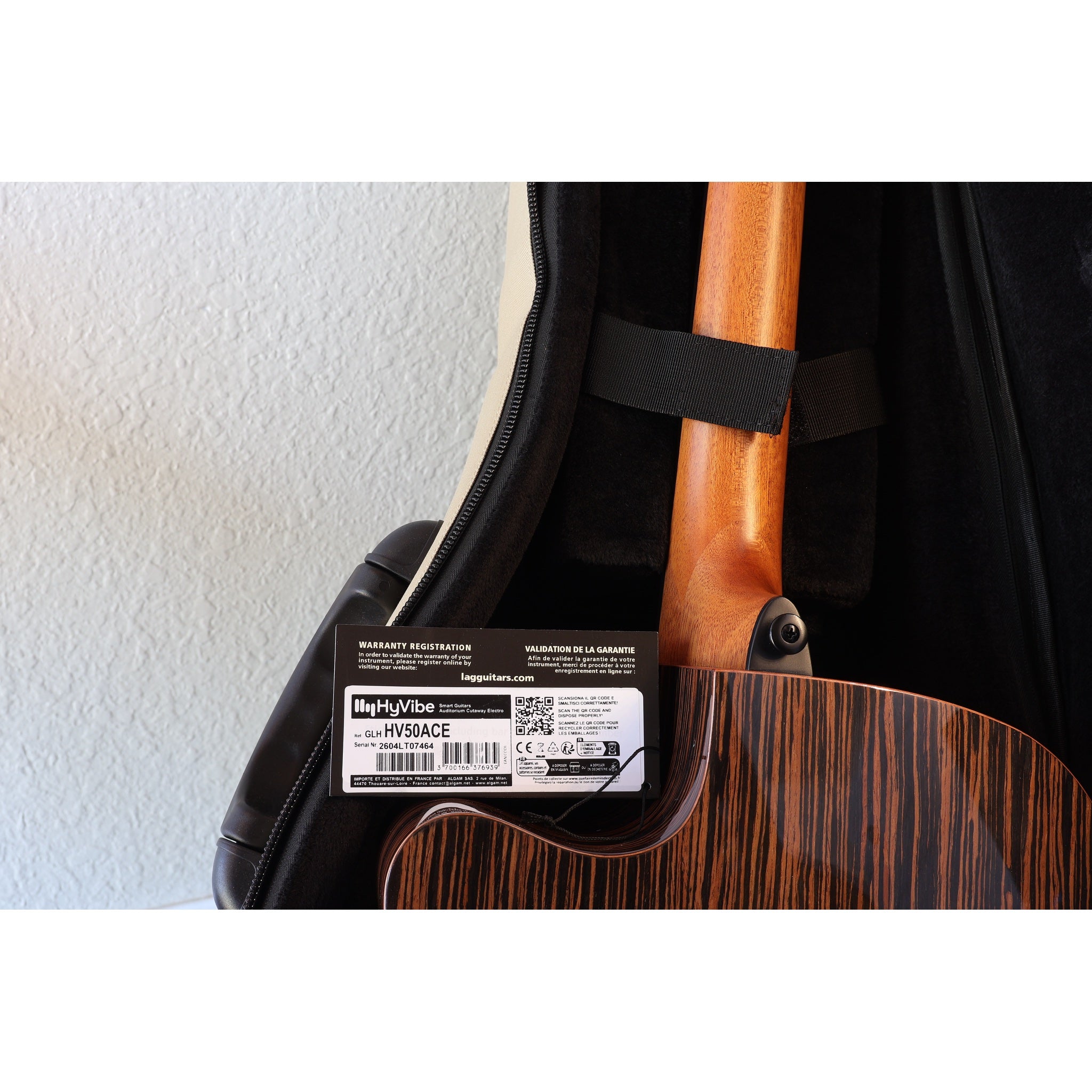 Lâg HyVibe 50 Auditorium Bevel Cutaway Smart Guitar – HV50ACE-2604LT07464 in case warranty registration card, serial number, upc, and neck/ back showing.