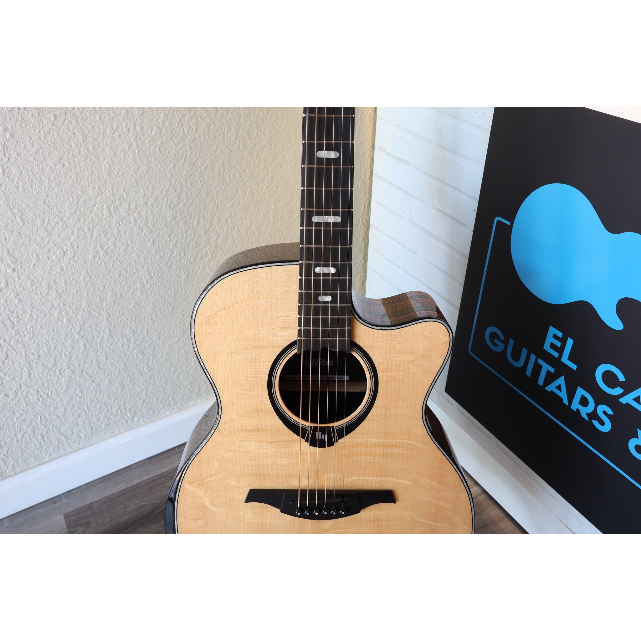 Lâg HyVibe 50 Auditorium Bevel Cutaway Smart Guitar – HV50ACE-2604LT07464 front body bridge, face, upper bout, and lower fretboard showing.