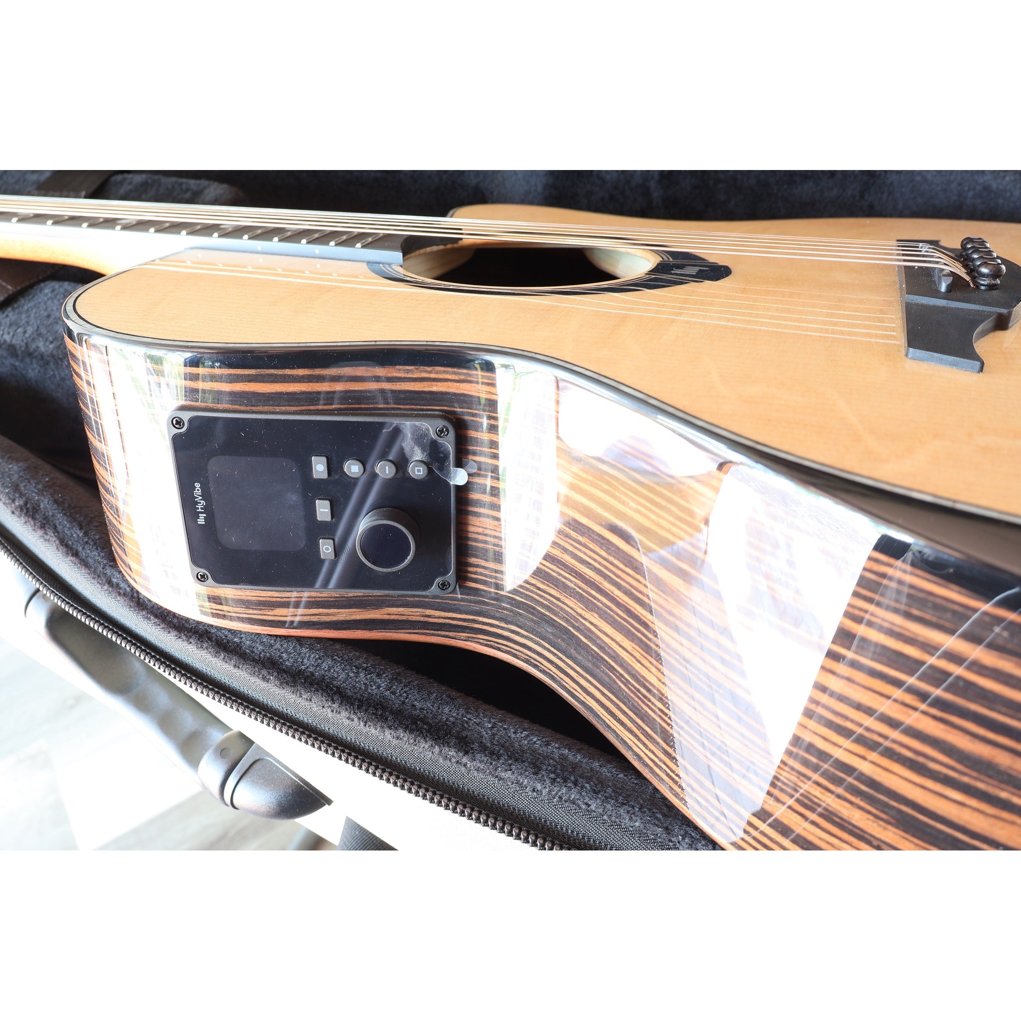 Lâg HyVibe 50 Auditorium Bevel Cutaway Smart Guitar – HV50ACE-2604LT07464 in case with side Hyvibe H2 electronics and side grain visible.