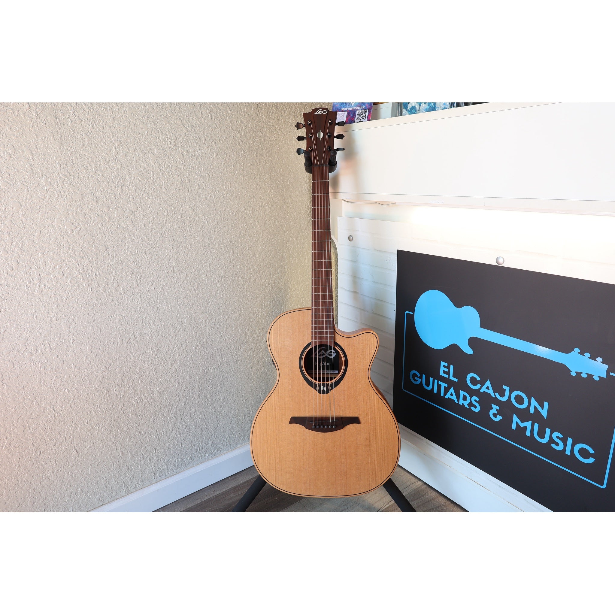 This Lâg HyVibe 10 HV10ACE, Serial Number 2604LT07360 full guitar front in stand at El Cajon Guitars & Music.