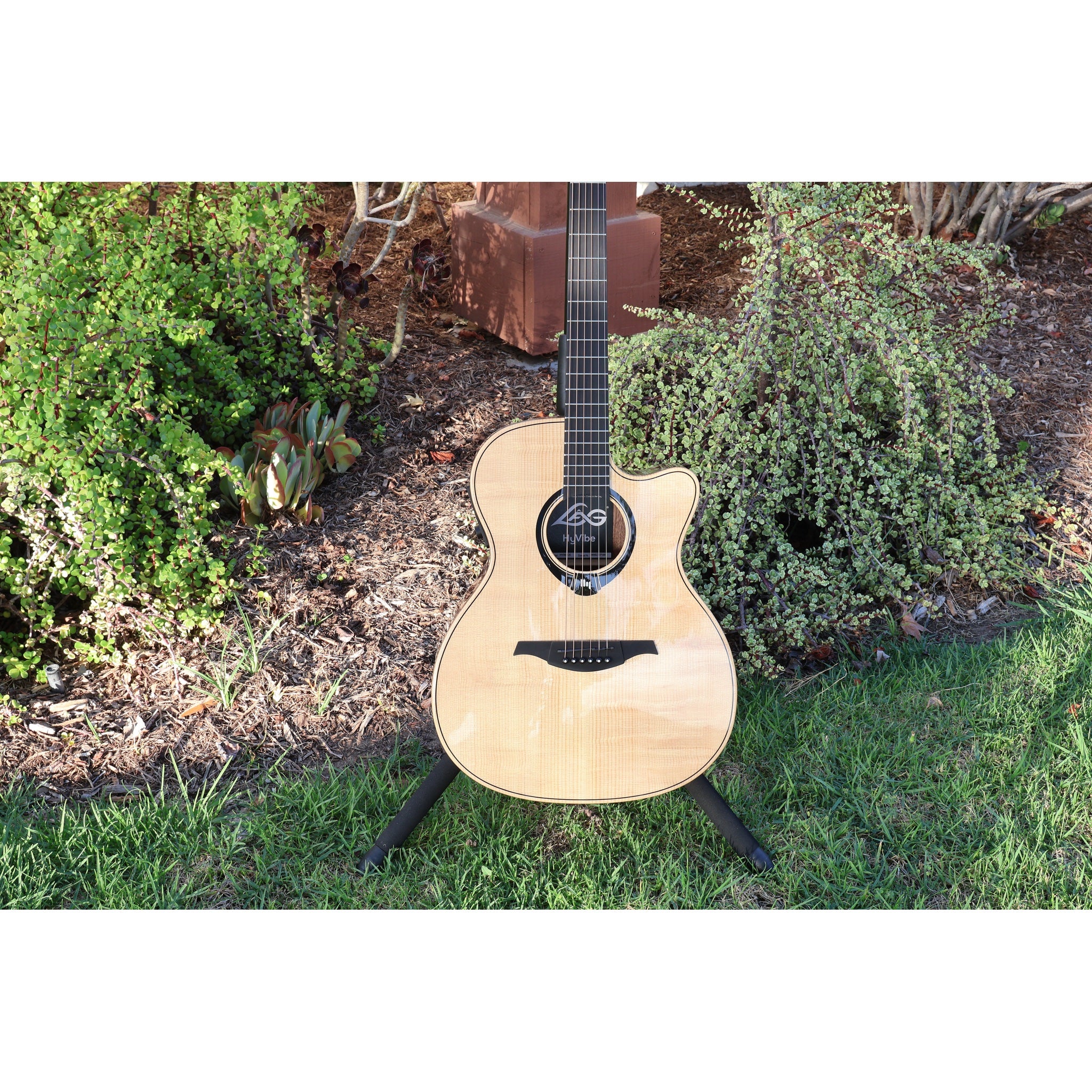 Lag Smart Guitar Hyvibe 30 Auditorium Cutaway Gloss at ECG Music - acoustic guitar in stand at ECGMusic - body closeup