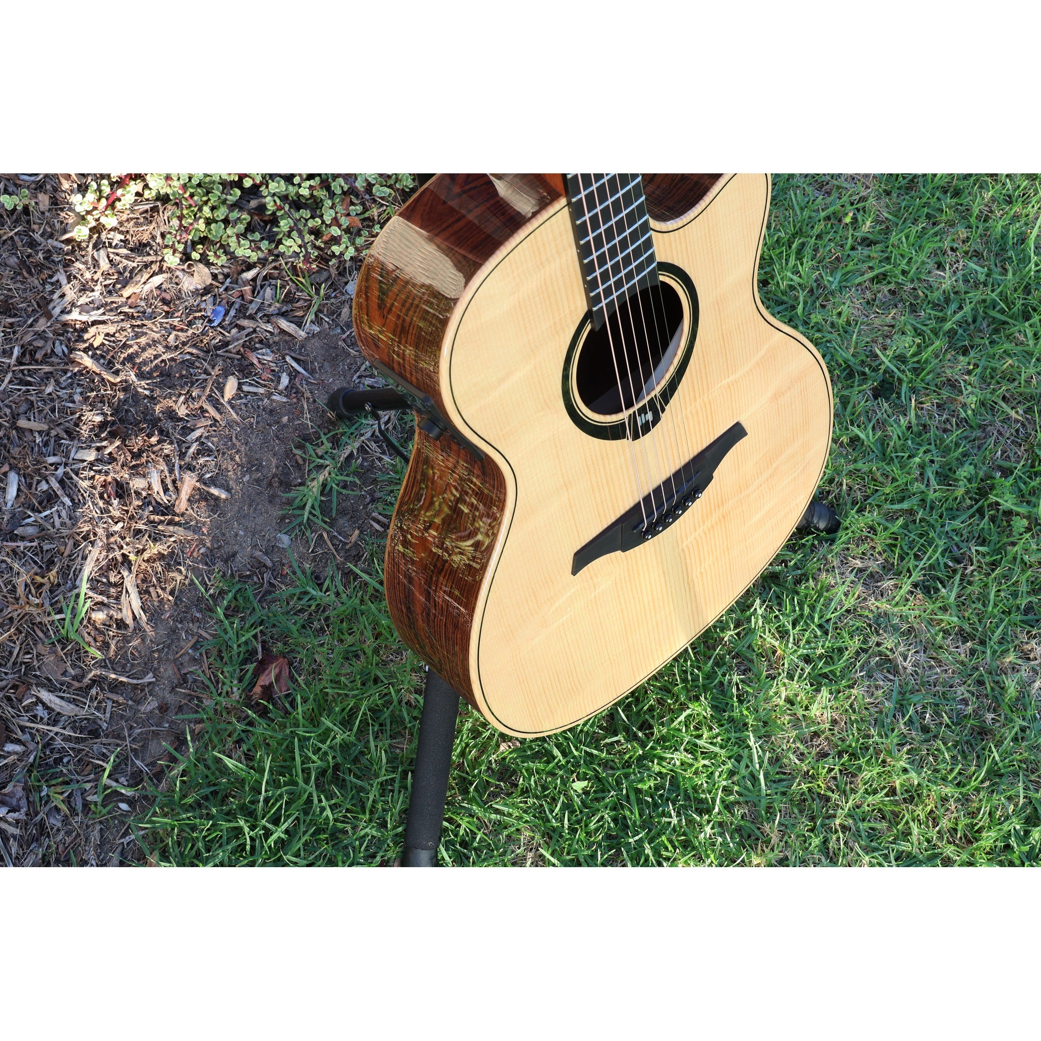 Lag Smart Guitar Hyvibe 30 Auditorium Cutaway Gloss at ECG Music on stand in grass.