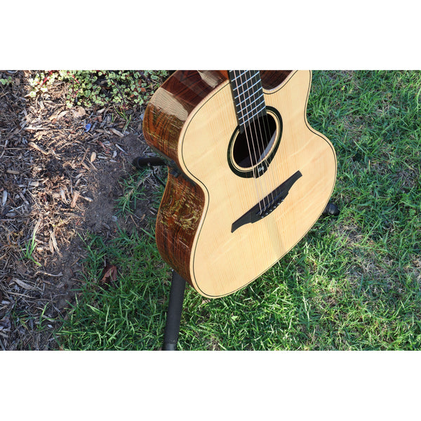 Lag Smart Guitar Hyvibe 30 Auditorium Cutaway Gloss at ECG Music on stand in grass.