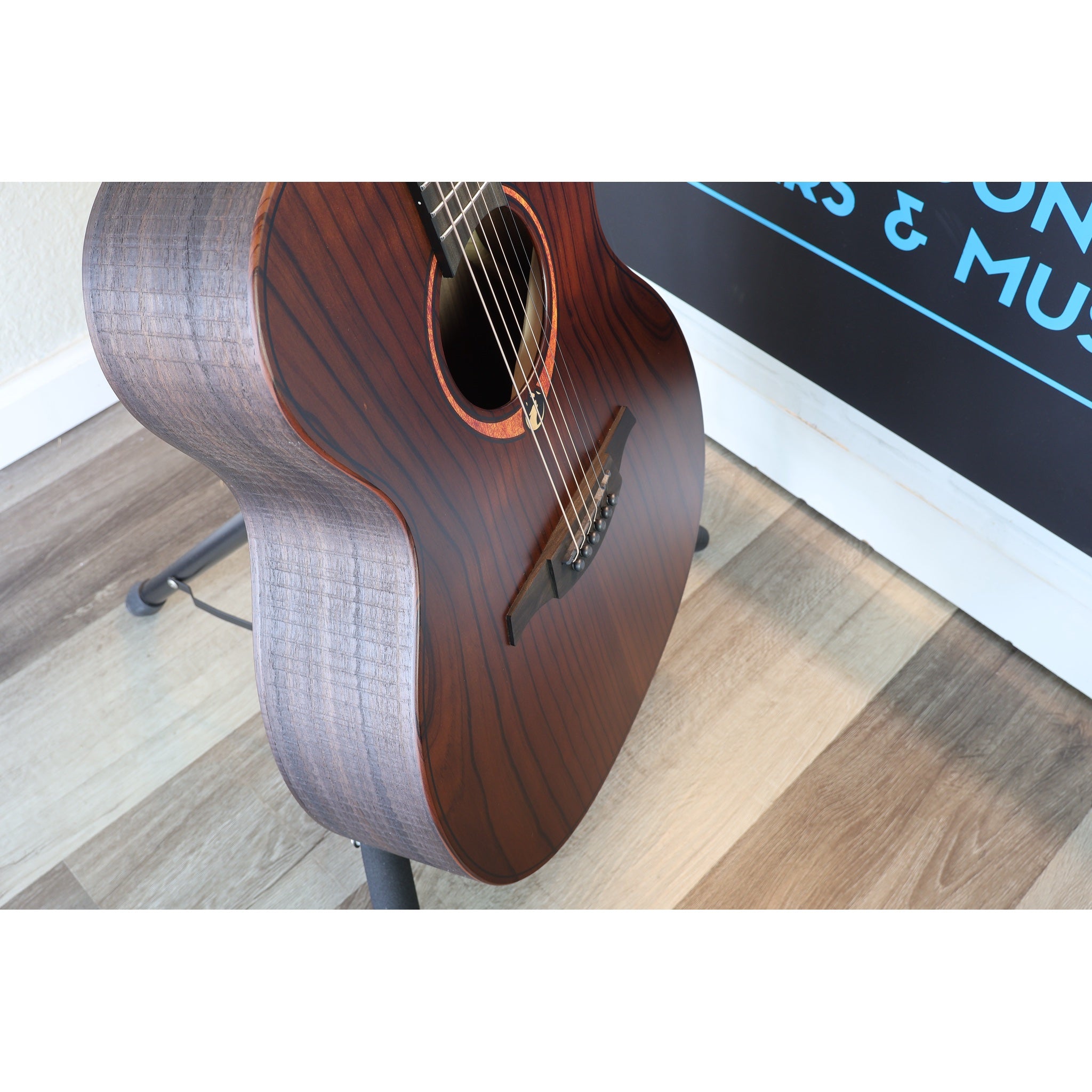 This Lâg Sauvage-A Auditorium Acoustic Guitar with Serial 2511LT20951, player side for right handed guitar player and top body view showing wood grain.  It does not have electronics and is purely acoustic.