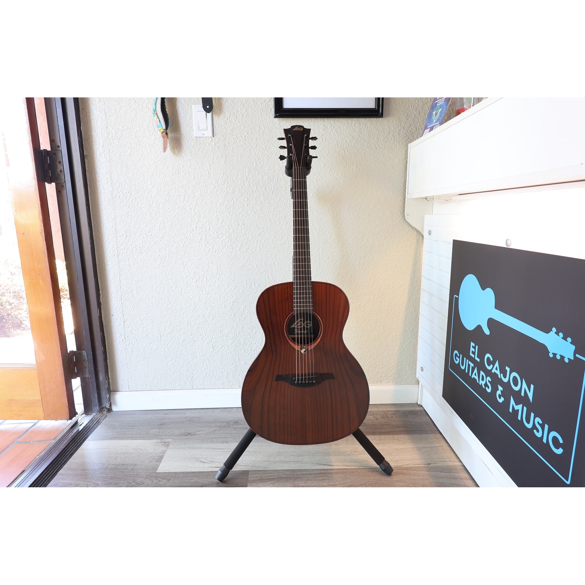 Full guitar in stand showing beautiful top grain.