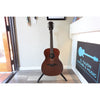 Full guitar in stand showing beautiful top grain.